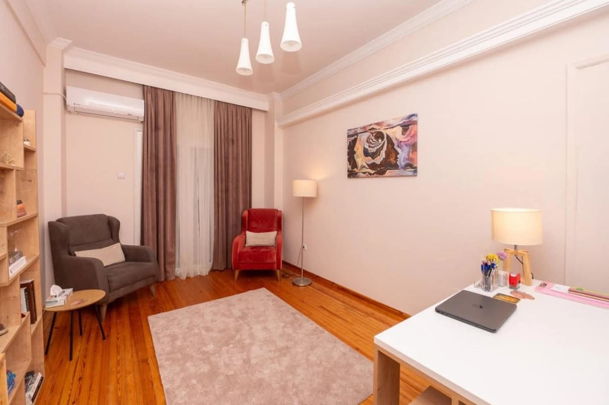 Home office space with desk and comfortable seating area