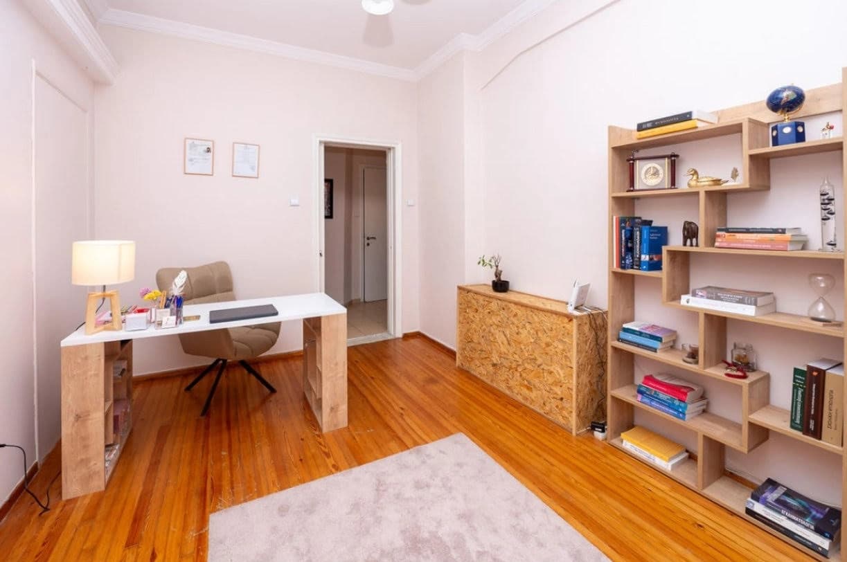Study room with wooden desk and organized bookshelf